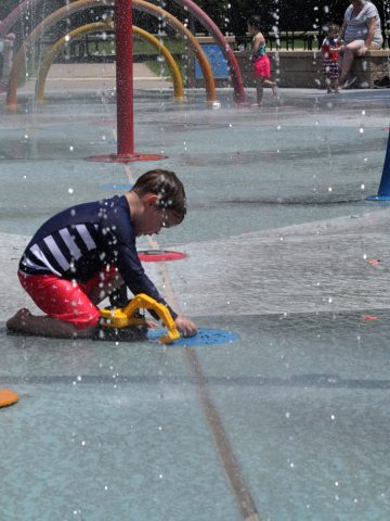 Playing with toy truck at splashpad