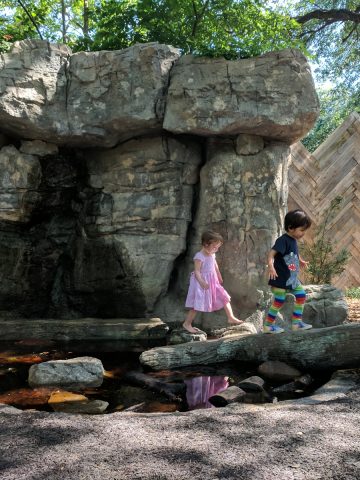 Walking on a log at Wild Nature Play Area at Houston Zoo