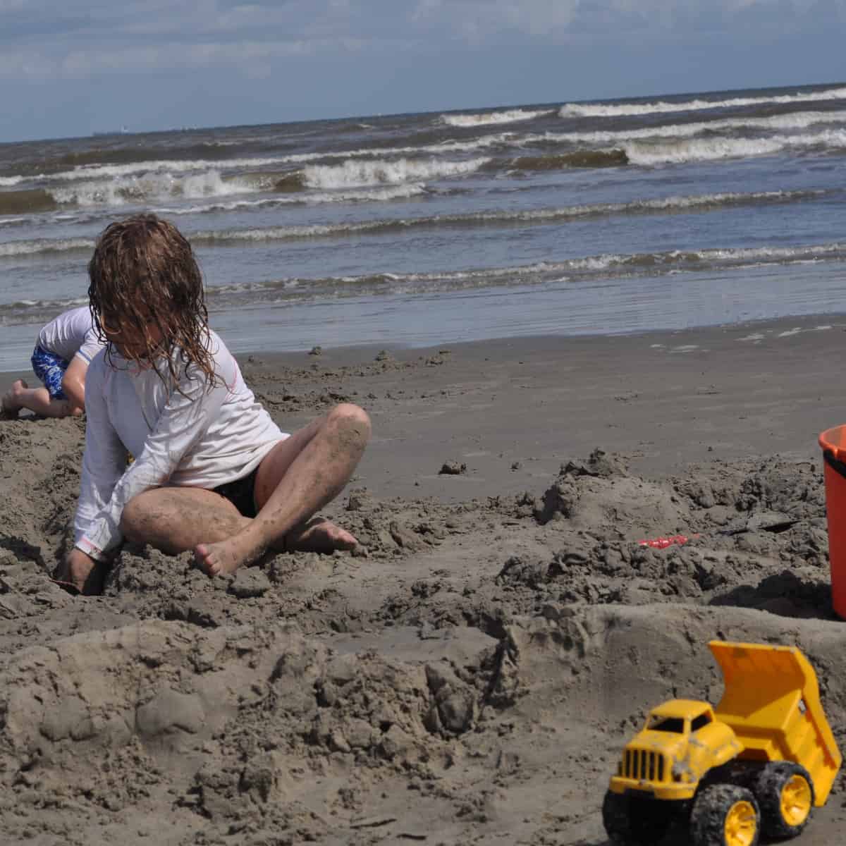 Playing in sand at Stewart Beach
