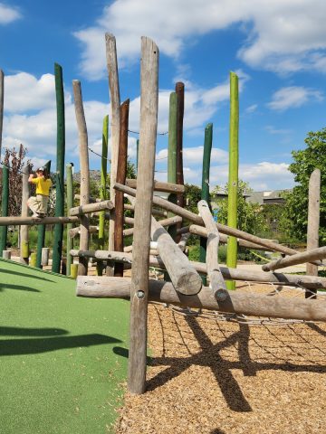 Climbing on log play structure at Evelyns Park