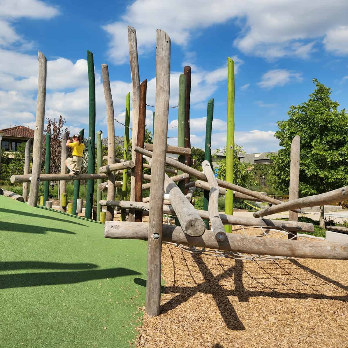 Climbing on log play structure at Evelyns Park
