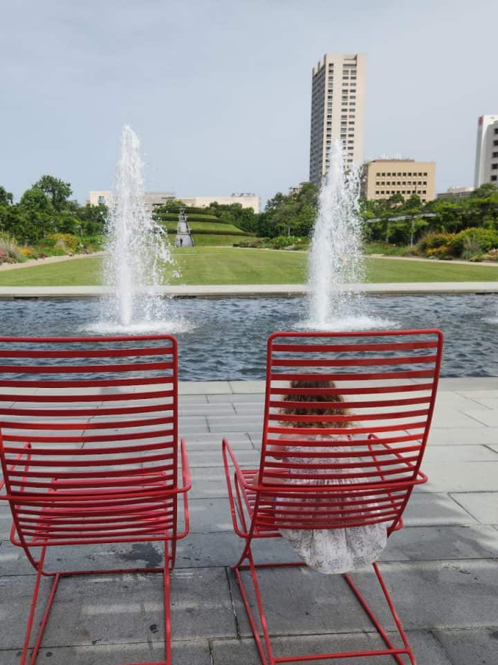 Hermann Park Centennial Garden Chair in from of fountain