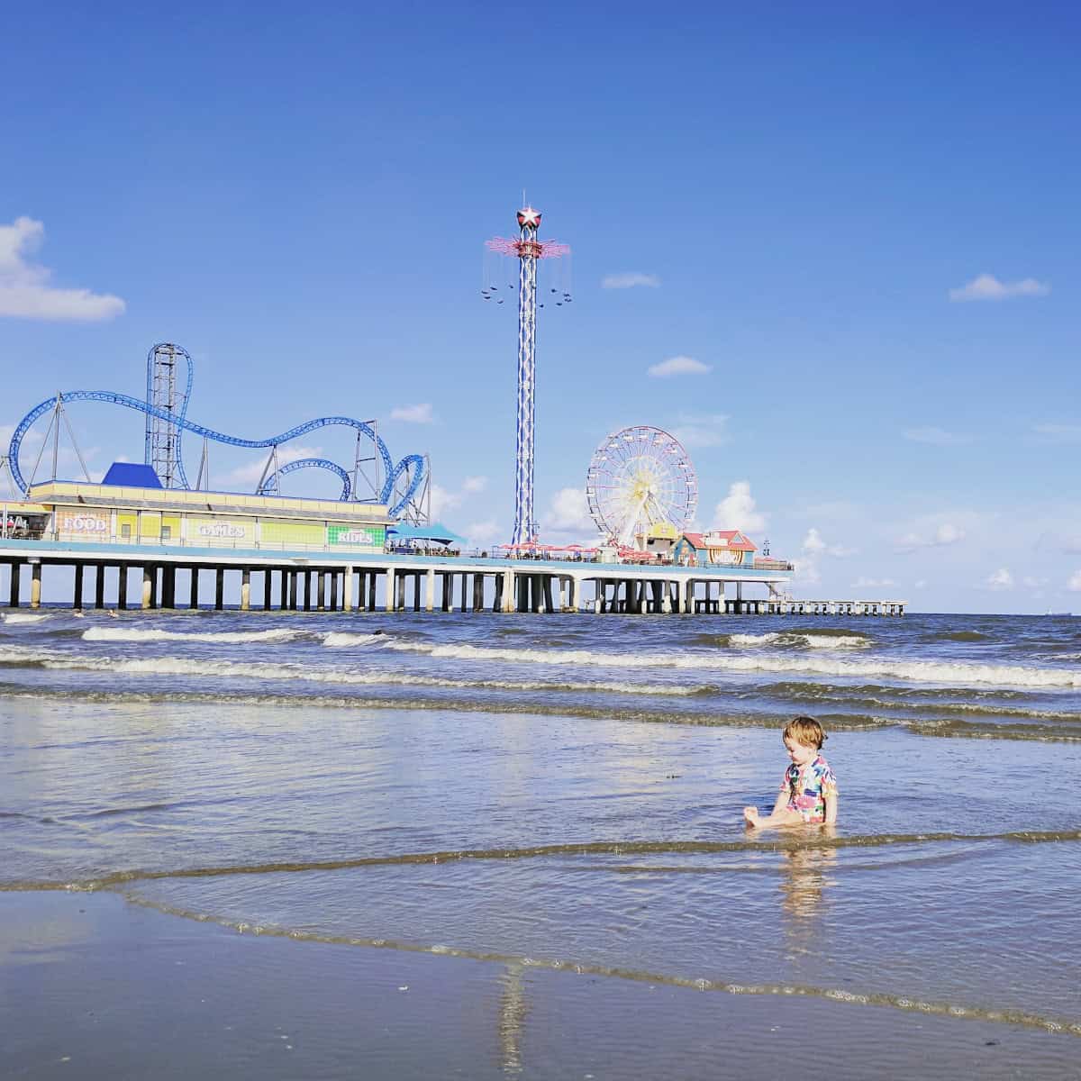 Toddler on the beach at Pleasure Pier Galveston